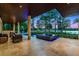 Wide patio with an elegant seating area, pool, and hot tub featuring beautiful views of the waterfront at 10122 Royal Island Ct, Orlando, FL 32836