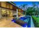Resort-style backyard with a pool, spa, and outdoor kitchen for ultimate relaxation and entertaining at 10122 Royal Island Ct, Orlando, FL 32836