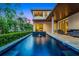 Beautiful pool with a fountain feature and views of the well-manicured backyard and second story balcony at 10122 Royal Island Ct, Orlando, FL 32836