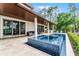 Inviting patio features a sparkling pool and spa, ideal for outdoor relaxation and entertainment at 10122 Royal Island Ct, Orlando, FL 32836