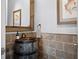 Charming powder room with a unique barrel sink, rustic mirror, and decorative fish artwork at 10122 Royal Island Ct, Orlando, FL 32836