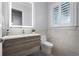 Modern powder room featuring floating vanity, a large mirror, and a toilet at 10122 Royal Island Ct, Orlando, FL 32836