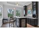 Modern wet bar with custom cabinetry, stone accents, and views of the lake at 10122 Royal Island Ct, Orlando, FL 32836
