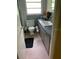 Practical bathroom with pink tiled floor, standard white toilet, and gray vanity at 1022 E 3Rd Ave, Mount Dora, FL 32757