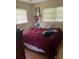Inviting bedroom with hardwood floors, two windows, and comfortable furnishings at 1022 E 3Rd Ave, Mount Dora, FL 32757
