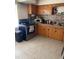 A functional kitchen offers tile flooring, wooden cabinets, and modern appliances at 1022 E 3Rd Ave, Mount Dora, FL 32757
