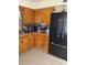 Cozy kitchen with plentiful wooden cabinetry and modern black refrigerator at 1022 E 3Rd Ave, Mount Dora, FL 32757