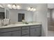 Double vanity bathroom with granite countertops and a decorative mirror, offering ample space and elegance at 11287 Stewart Loop, Oxford, FL 34484