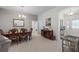 Elegant dining area with wooden table and chairs, complemented by a decorative sideboard and light fixtures at 11287 Stewart Loop, Oxford, FL 34484