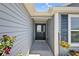 Welcoming front entryway featuring a stylish black door and decorative accents at 11287 Stewart Loop, Oxford, FL 34484