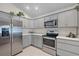 Beautiful kitchen featuring gray cabinets and stainless steel appliances at 11287 Stewart Loop, Oxford, FL 34484