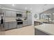 Modern kitchen boasts stainless steel appliances and sleek gray cabinetry at 11287 Stewart Loop, Oxford, FL 34484