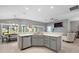 Open kitchen with stainless appliances and a breakfast bar, connects to the living area at 11287 Stewart Loop, Oxford, FL 34484