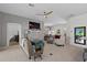 Bright, open living room features a ceiling fan, comfortable seating, and views into the dining area at 11287 Stewart Loop, Oxford, FL 34484