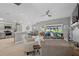 Open-concept living area boasts a modern kitchen, dining space, and cozy seating with backyard access at 11287 Stewart Loop, Oxford, FL 34484