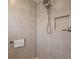 Modern shower with sleek tiles, a rainfall showerhead, and a built-in niche for toiletries at 11287 Stewart Loop, Oxford, FL 34484