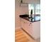 Stylish kitchen island with dark countertops, modern sink and faucet, and a view of the outdoors at 1225 E 1St Ave, Mount Dora, FL 32757