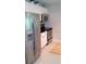 Bright kitchen featuring stainless steel appliances, white cabinets, granite countertops, and wood-look flooring at 1225 E 1St Ave, Mount Dora, FL 32757