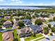 Aerial view shows the property in a neighborhood near a lake, highlighting the community's charm and access to nature at 12833 Hyland Ln, Clermont, FL 34711