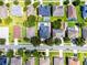 Aerial view of neighborhood with mature trees and private pools at 12833 Hyland Ln, Clermont, FL 34711