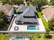 Overhead view of the backyard highlighting the pool, hot tub, and outdoor entertaining space, all within a fenced yard at 12833 Hyland Ln, Clermont, FL 34711
