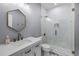 Bathroom featuring a white vanity, decorative mirror, and stylish glass shower at 12833 Hyland Ln, Clermont, FL 34711
