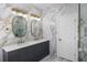 Double vanity bathroom with marble walls and gold finishes at 12833 Hyland Ln, Clermont, FL 34711