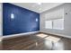 Bedroom with panel wall, wood floors, and a bright window at 12833 Hyland Ln, Clermont, FL 34711
