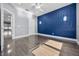 Bedroom with panel wall, wood floors, and a bright window at 12833 Hyland Ln, Clermont, FL 34711