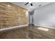 Bedroom with hardwood floors and wood panel wall at 12833 Hyland Ln, Clermont, FL 34711