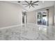 Bright, open bedroom with marble floors and sliding glass doors to the patio at 12833 Hyland Ln, Clermont, FL 34711