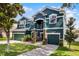 Elegant two-story home with a three-car garage, stone accents, and well-maintained landscaping at 12833 Hyland Ln, Clermont, FL 34711