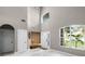 Grand foyer with soaring ceilings, elegant chandelier, and white marble floors at 12833 Hyland Ln, Clermont, FL 34711