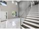 Foyer with stairs, glass railing, and modern finishes at 12833 Hyland Ln, Clermont, FL 34711
