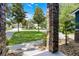 View of a landscaped front yard with mature trees and a glimpse of neighboring homes at 12833 Hyland Ln, Clermont, FL 34711