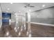 Spacious living room with hardwood floors, wet bar, and neutral color palette at 12833 Hyland Ln, Clermont, FL 34711