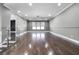 Spacious living room with wood floors and modern ceiling fan at 12833 Hyland Ln, Clermont, FL 34711