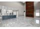 Spacious living area with a fireplace, open to the kitchen, and marble flooring at 12833 Hyland Ln, Clermont, FL 34711