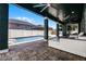 Covered patio with fan overlooking pool and backyard with lounge seating at 12833 Hyland Ln, Clermont, FL 34711