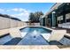Resort-style pool with in-water lounge chairs and lush landscaping at 12833 Hyland Ln, Clermont, FL 34711