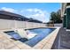 Backyard pool featuring in-water lounge chairs and mature landscaping at 12833 Hyland Ln, Clermont, FL 34711