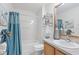 Bright bathroom features a tub with shower, and a neutral vanity with a framed mirror at 1291 Jonesville Ter, The Villages, FL 32162
