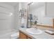 Bright bathroom with vanity, framed mirror, and tub with shower, and modern accessories at 1291 Jonesville Ter, The Villages, FL 32162