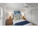 Bedroom with ceiling fan, window, and blue accents and modern lamps at 1291 Jonesville Ter, The Villages, FL 32162