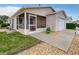 Charming single-story home with a screened-in porch and well-maintained landscaping at 1291 Jonesville Ter, The Villages, FL 32162