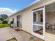 Back exterior view of a home with a screened patio and a propane grill at 1291 Jonesville Ter, The Villages, FL 32162