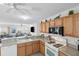 A well-equipped kitchen offering views into the living room; ample cabinet space at 1291 Jonesville Ter, The Villages, FL 32162