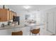 Efficient kitchen with modern appliances and breakfast bar seating; ample counter space at 1291 Jonesville Ter, The Villages, FL 32162
