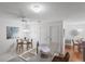 Open kitchen and dining area with white cabinets, tile flooring, and updated fixtures at 1291 Jonesville Ter, The Villages, FL 32162