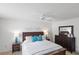 Comfortable main bedroom with white walls, carpet, dresser, and ceiling fan at 1291 Jonesville Ter, The Villages, FL 32162